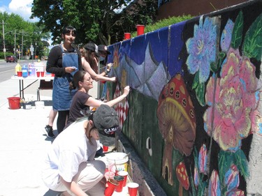 Maria Khan (standing), teacher Betty Carter-Edwards and Raven Wang (closest to camera) among those working on a CHEO bear picnic mural as part of the chalkathon at CCVS. Photo on Friday, June 3, 2022, in Cornwall, Ont. Todd Hambleton/Cornwall Standard-Freeholder/Postmedia Network