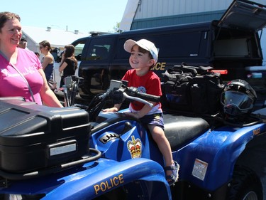 Three-year-old Logan Armstrong, of Chesterville, on an OPP ATV while mom Cathy Belair looks on. Photo on Saturday, June 11, 2022, in Crysler, Ont. Todd Hambleton/Cornwall Standard-Freeholder/Postmedia Network