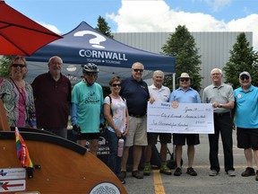 Members of Cornwall's Senior-Friendly Community Committee, Rotary Club of Cornwall Sunrise, and city representatives posed for a photo with a donation for Cornwall's Seniors on Wheels program. The new style of trishaw can be seen in the foreground, on Tuesday June 14, 2022 in Cornwall, Ont. Shawna O'Neill/Cornwall Standard-Freeholder/Postmedia Network