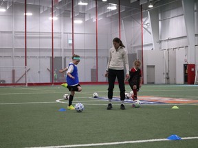 Stephanie Labbé's coaches train participants at a stop in Cornwall on her national tour. Left to right: Ainsley Ladouceur, 8, Stephanie Labbé, Jersey Martineau, 8 on Tuesday, June 21, 2022 in Cornwall, Ont. Laura Dalton/Cornwall Standard-Freeholder/Postmedia Network