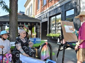 From left, Daimon and Leila Montour having their portraits drawn by Jade Thompson during Cornwall Art Walk on Friday June 24, 2022 in Cornwall, Ont. Shawna O'Neill/Cornwall Standard-Freeholder/Postmedia Network