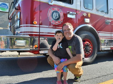 From left, Sully Rogers, celebrating his 2nd birthday with dad Drew at the Touch-a-Truck event on Tuesday June 28, 2022 in Cornwall, Ont. Shawna O'Neill/Cornwall Standard-Freeholder/Postmedia Network