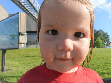 Axton McCracken was very interested in the camera, after running around in the big sprinkler pictured in the background at the Touch-a-Truck event on Tuesday June 28, 2022 in Cornwall, Ont. Shawna O'Neill/Cornwall Standard-Freeholder/Postmedia Network