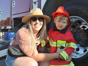 From left, Madison and Lyle Richardson having fun at Touch-a-Truck on Tuesday June 28, 2022 in Cornwall, Ont. Shawna O'Neill/Cornwall Standard-Freeholder/Postmedia Network
