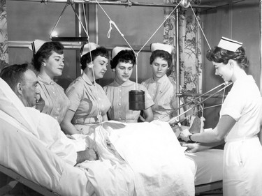 Handout/Cornwall Standard-Freeholder/Postmedia Network
From the Religious Hospitallers of St. Joseph archives, an undated photo of nurses surrounding a patient-- note the various cables being used to immobilize a leg.