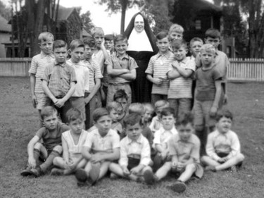 Handout/Cornwall Standard-Freeholder/Postmedia Network
From the Religious Hospitallers of St. Joseph archives, Sister Clancy stands with a group of orphans from the Nazareth Orphanage in this undated photo.