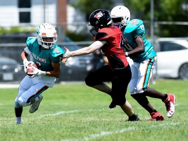 A Durham Dolphins ball carrier makes a move to avoid a Cornwall Wildcats defender during play on Saturday June 4, 2022 in Cornwall, Ont. The Wildcats won 32-0. Robert Lefebvre/Special to the Cornwall Standard-Freeholder/Postmedia Network