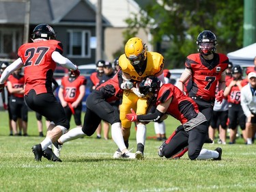 Two Cornwall Wildcats players work to tackle a Kingston Jr. Gaels player on Saturday June 18, 2022 in Cornwall, Ont. Cornwall lost 34-23. Robert Lefebvre/Special to the Cornwall Standard-Freeholder/Postmedia Network