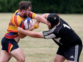 Kent Havoc's Jordan Deneau, left, is hit by Stratford Blackswans' Dawson Currie in the second half of a Niagara Rugby Union men's B division game at Victoria Park in Chatham, Ont., on Saturday, July 14, 2018. Mark Malone/Chatham Daily News/Postmedia Network