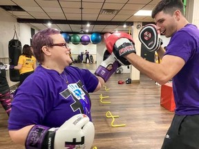 Jorden Nixon practices with coach Sam Weber at Fierce N Fit Boxing in Kitchener. The gym offers in person and online fitness classes for individuals with disabilities.