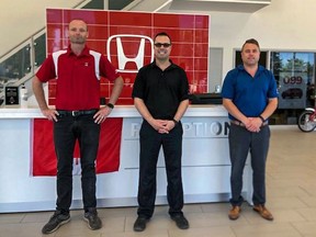 Managers Darren Goodayle, left, Rob Lantz and Dave Lantz stand in the Hanover Honda showroom, which has been updated with many energy saving features.