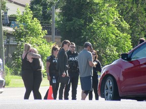 Bystanders gather at the police road closure at Collins Bay Road and Taylor Kidd Boulevard during Monday afternoon's collision at Coronation and Taylor Kidd boulevards in Kingston, on Monday.