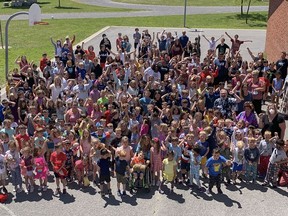 The Kindergarten to Grade-8 students and staff at St. Martha Catholic School in Kingston's east-end gather for a big school year-end photo in the schoolyard on the second last day of the 2021-2022 school year after the celebration assembly on Tue., June 28, 2022.