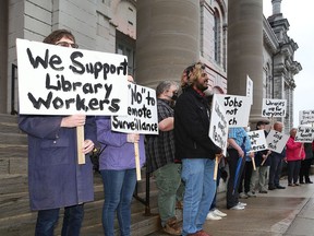 Approximately 15 protesters showed up to Kingston City Hall to protest the proposal for staffless library hours at the Pittsburgh Branch of the Kingston Frontenac Public Library on Tuesday.