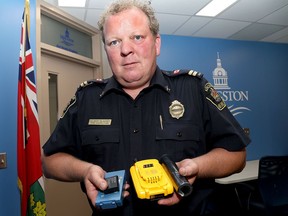 Fire inspector Delbert Blakney holds up lithium-ion batteries at the Kingston Fire and Rescue headquarters on Thursday.