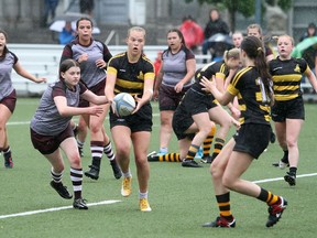 Hadley McPherson of the La Salle Black Knights passes to a teammate while playing against the Frontenac Falcons in the Kingston Area Secondary Schools Athletic Association girls rugby final on a wet Nixon Field in Kingston on Tuesday, June 7, 2022. La Salle won the game, 12-0.