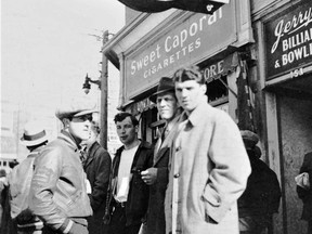Can you name any of these individuals taking a break outside of the United Cigar Store and Jerry's Billiards & Bowling in downtown Kirkland Lake?