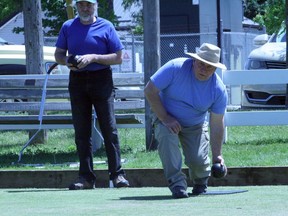 Drew Dalgleish of Centralia bowls at an Exeter Lawn Bowling Club open house Sat., June 4 while Exeter's Doug Westlake looks on.
