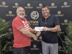 Saverio Rinaldi, left, co-chair of the Grand Bend Canada Day organizing committee, accepts a $5,000 cheque from Jeff Kints, owner of Southwest Marine and Powersports and Needham's Marine Limited. Canada Day celebrations in Grand Bend will include musical entertainment and fireworks. Handout