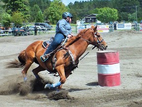 Photo by LESLIE KNIBBS
One of the youth participants rounds a barrel in the Barrel Racing event.