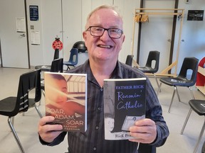 Author Rick Prashaw displays his books, Soar, Adam, Soar, and Father Rick, Roamin' Catholic.