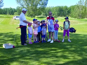 Tim Collis, president of the Nanton Golf Club, and Nanton Mayor Jennifer Handley, along with junior golfers, officially opened the club's three-hole junior golf course June 10.