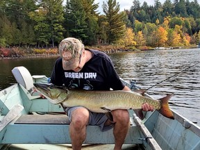 The author with a trophy 50-inch muskie he caught and released from a lake in the Quebec Laurentians.