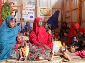 Internally displaced Somali women carry their children as they wait for malnutrition screening at the Dollow hospital in Dollow, Gedo Region, Somalia, on May 24.