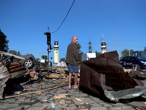A local resident stands among debris following a military strike as Russia's attack on Ukraine continues in Kharkiv, Ukraine, on June 9.