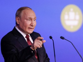 Russian President Vladimir Putin delivers a speech during a session of the St. Petersburg International Economic Forum in St. Petersburg, Russia, on Friday.
