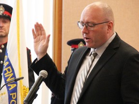 Sarnia's new police chief Derek Davis recites oaths of office and secrecy May 31, at Sarnia city hall.  Davis takes over from outgoing police chief Norm Hansen.  (Tyler Kula/ The Observer)