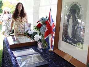 Rachel Veilleux with the City of Sarnia stands by a memorabilia table at a garden party in Sarnia's Germain Park Saturday in honour Queen Elizabeth II's Platinum Jubilee. (Tyler Kula/ The Observer