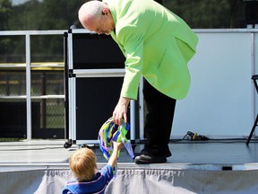 Magician Peter Mennie hands a prop to William Gray, 5, from Sarnia during Kids Funfest at Clearwater Park on Saturday, June 11, 2022 in Sarnia, Ont.  Terry Bridge/Sarnia Observer/Postmedia Network
