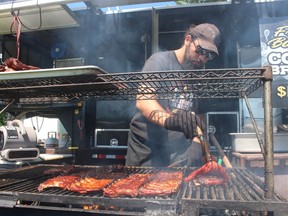 Fordd Wroblewsk, with Smoke House Bandits of London, mans the grill Friday at the Sarnia Kinsmen Ribfest in Centennial Park.  The event runs through Sunday.
