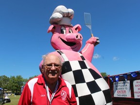 Jack Struck, co-chairperson of the Sarnia Kinsmen Ribfest, stands at the front gate of the event Friday in Centennial Park with his new mascot.  Ribfest runs through Sunday.  (PAUL MORDEN/The Observer)