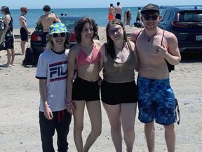 High school students Max Benoit, from left, Britt Wills, Jaelynn Fowler, and Jaxon Ferral, all 18 years of age, joined some of their peers at the Turkey Point beach on Friday for Beach Day.  On Beach Day, held the first Friday in June, students say goodbye to the classroom and head to the beach.  ALEX HUNT PHOTO