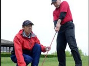 Gerry Nelson, right, a visually impaired golfer, prepares to take a swing. With him is his coach Chris Villeneuve.   The Canadian Blind Golf Open and The Ontario Blind Golf Championship is set to be held August 6 to 12 at the Green At Renton near Simcoe. CONTRIBUTED