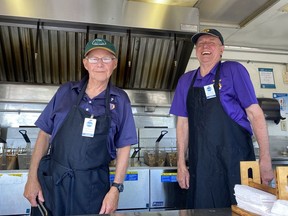 Simcoe Lions Club members Wayne Winter, left, and Doug Hunt took a short break from their cooking duties in the Lions Club food trailer at the Norfolk Night Market on Friday.  The inaugural market, which ran Friday and Saturday at the Simcoe fairgrounds, featured artisans, food, drinks and entertainment.  SIMCOE REFORM
