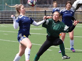 Arijana Tuttle, left, of College Notre-Dame, and Liz Uguccioni, of Lockerby Vikings, battle for the ball during girls high school soccer action at James Jerome Sports Complex in Sudbury, Ont. on Wednesday April 27, 2022. Scheduling high school soccer in Sudbury is a challenge, Dave Makela writes. John Lappa/Sudbury Star/Postmedia Network