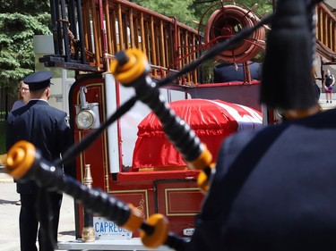 A 1929 fire truck is used to transport the casket of Greater Sudbury firefighter Mike Frost at a funeral procession in downtown Sudbury, Ont. on Wednesday June 1, 2022. John Lappa/Sudbury Star/Postmedia Network