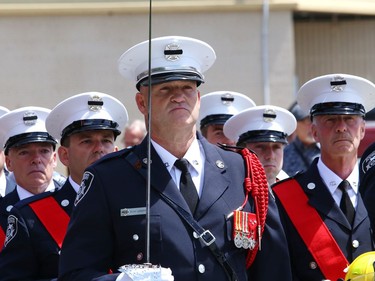 Members of the Greater Sudbury firefighters honour guard stand at attention during a funeral procession for Greater Sudbury firefighter Mike Frost in downtown Sudbury, Ont. on Wednesday June 1, 2022. John Lappa/Sudbury Star/Postmedia Network