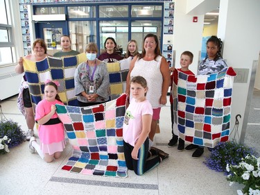 Members of the Knitting Club at Chelmsford Valley District Composite School in Chelmsford, Ont., presented four blankets to Tannys Laughren, lead of Volunteer Services at Health Sciences North on Wednesday June 15, 2022. More than 30 elementary school students from the school have been working on their knitting skills before classes start in the morning and during recess, and at the same time, contributing to knitted blankets for cancer patients at the Northeast Cancer Centre. John Lappa/Sudbury Star/Postmedia Network