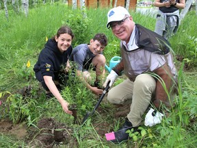Emma Lascelle, 11, left, and Erik Del Papa, 12, of R.L. Beattie Public School, participate in planting native shrubs and wildflowers under the guidance of Tim Hickey, of TD Private Wealth Management, at Kivi Park in Sudbury, Ont. on Thursday June 16, 2022. More than 125 Grade 5 and 6 students from the school planted 1265 plants thanks to TD Canada's Friends of the Environment Foundation Grant. TD Canada has donated $25,000 over two years to support Kivi ParkÕs re-greening efforts. John Lappa/Sudbury Star/Postmedia Network