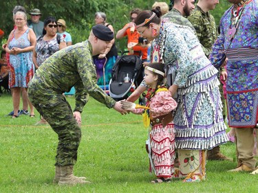 Sgt. Adam Marcil, of the Second Battalion Irish Regiment of Canada, is greeted by Hailey Sutherland and her daughter, Amelia, 3, at a pow wow event celebrating National Indigenous Peoples Day at Bell Park in Sudbury, Ont. on Tuesday June 21, 2022. John Lappa/Sudbury Star/Postmedia Network