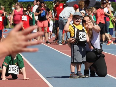 Nash Parcey, 6, of MacLeod Public School, waves to supporters at the Rainbow District School Board Challenge Meet at Laurentian Community Track Complex in Sudbury, Ont. on Thursday June 23, 2022. About 330 students with special needs from 22 Rainbow schools participated in a variety of track and field events, including races, high jump, long jump, softball throw and shot put. John Lappa/Sudbury Star/Postmedia Network
