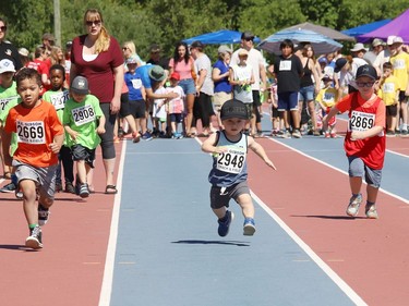 Bennett Lavoie, 7, middle, of Walden Public School, dashes down the track at the Rainbow District School Board Challenge Meet at Laurentian Community Track Complex in Sudbury, Ont. on Thursday June 23, 2022. About 330 students with special needs from 22 Rainbow schools participated in a variety of track and field events, including races, high jump, long jump, softball throw and shot put. John Lappa/Sudbury Star/Postmedia Network