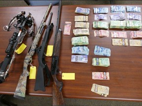 Pictured are the weapons and cash recovered during a drug raid in Chelmsford on March 17 of last year.