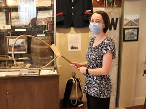 Forest Museum assistant Amy Jennings holds a train control hoop _ a device once used to relay messages to people on passing trains. Carl Hnatyshyn/Sarnia this week