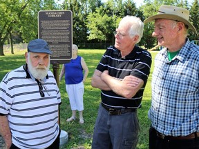 Plympton-Wyoming Mayor Lonny Napper (left) speaks with Plympton-Wyoming Historical Society members Bill Munro (centre) and Ed DeJong (right) after the unveiling of an historical plaque commemorating Mandaumin Museum on June 24. Carl Hnatyshyn/Sarnia This Week