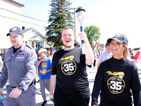Chad Palik, from left, Caleb Everett-Lessard, and Donna Bujold lead the Law Enforcement Torch Run in Iroquois Falls held on Thursday. Everett-Lessard was the guest of honour at the annual event that raises funds and awareness about the Special Olympics for athletes with intellectual disabilities. The Monteith Correctional Complex, where Palik is a member of the Crisis Intervention Team, and Bujold is a recreation officer, has been organizing the run for 34 years.

NICOLE STOFFMAN/The Daily Press